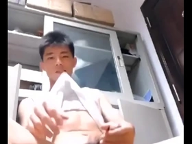 An Asian man pleasuring himself.