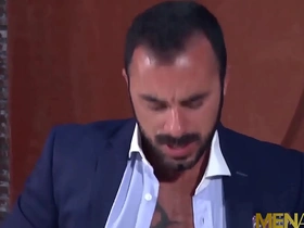 Muscular businessman Xavi Duran has anal sex with a blond gay in a office building.