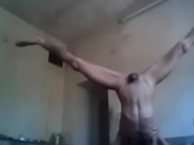 Naked woman doing splits in the gym