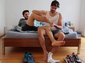 Gay men enjoying foot fetish activities like footjob and foot sniffing