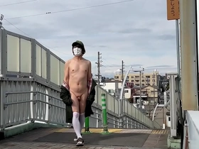 Sissy Ma Yuchan strips and pleases herself on a pedestrian bridge outdoors.
