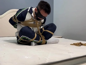 Young Asian man in white socks and shrimp tie bondage