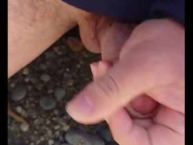 Japanese gay man masturbates outdoors on the beach.