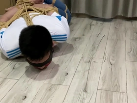 Asian boy in white socks and jeans gets hogtied and blindfolded