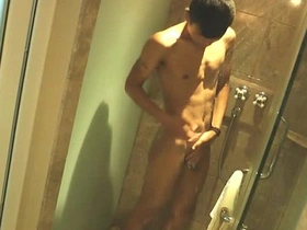 Young Asian man washing up in the shower with a dark skin tone.