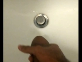 An Asian teen masturbates and ejaculates.