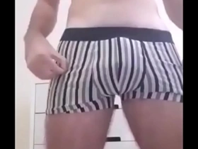 A young woman masturbates while talking dirty in front of a hidden camera.