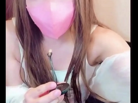 Beautiful Japanese crossdresser masturbates after a phone call.