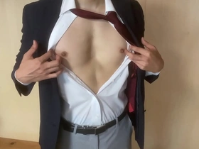 A gay Japanese man pleasuring himself dressed in a suit.